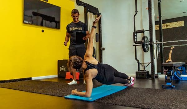 side plank variation being demonstrated by pure function fitness client