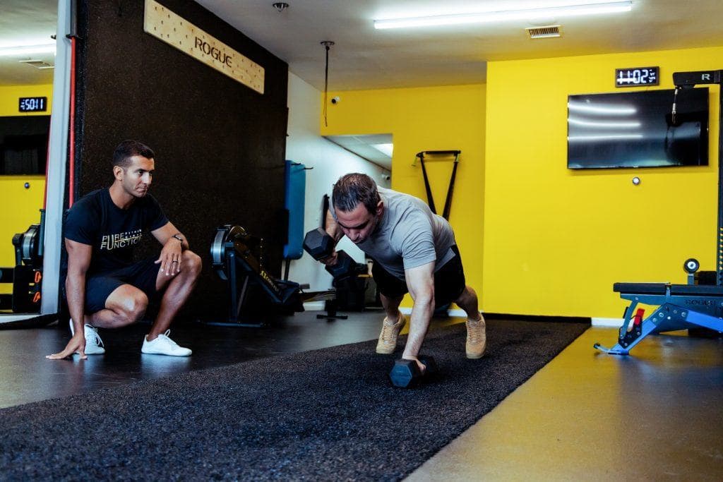 archers pushup being demonstrated by a personal trainer at pure function fitness