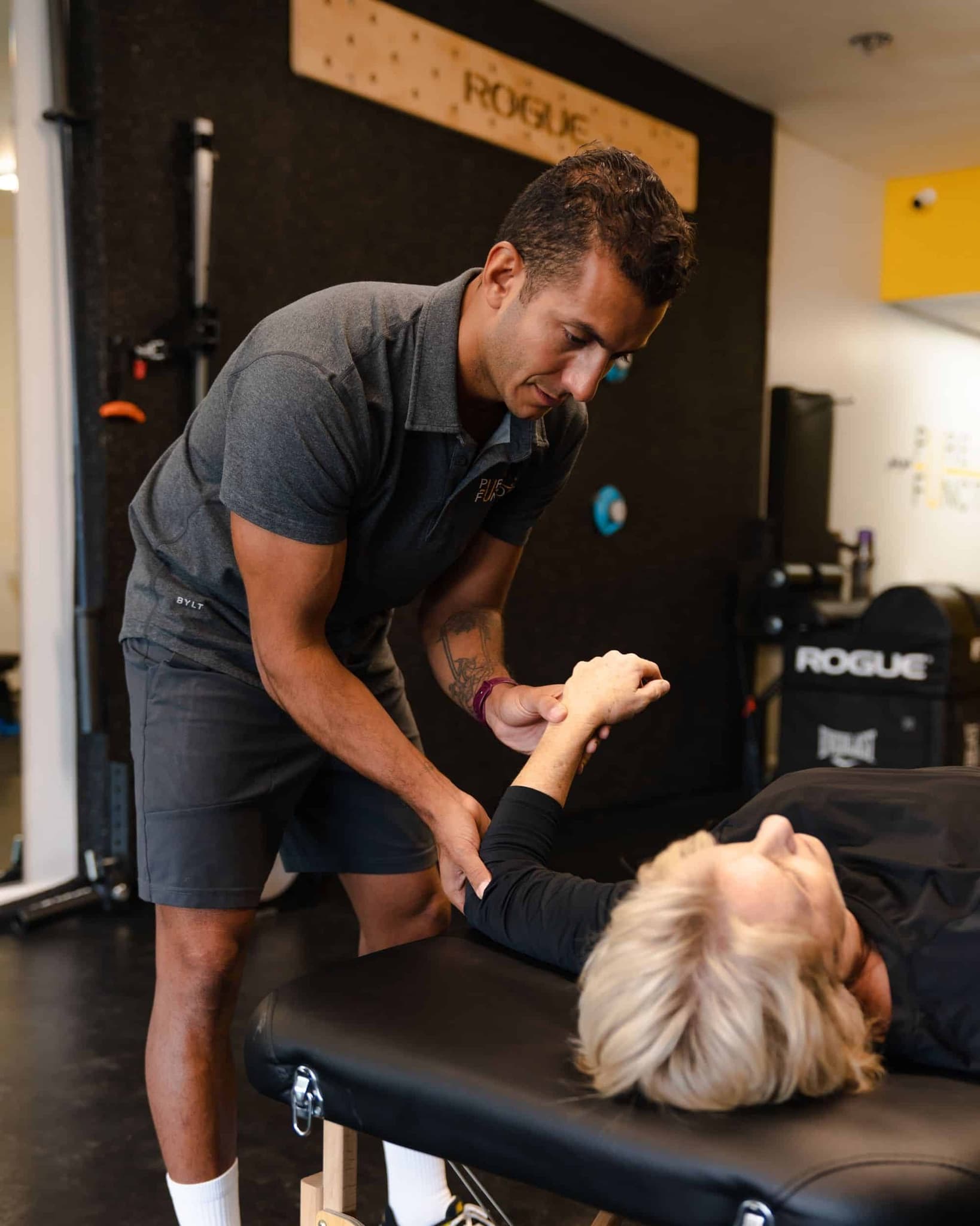 Coach measuring a client's overhead arm mobility