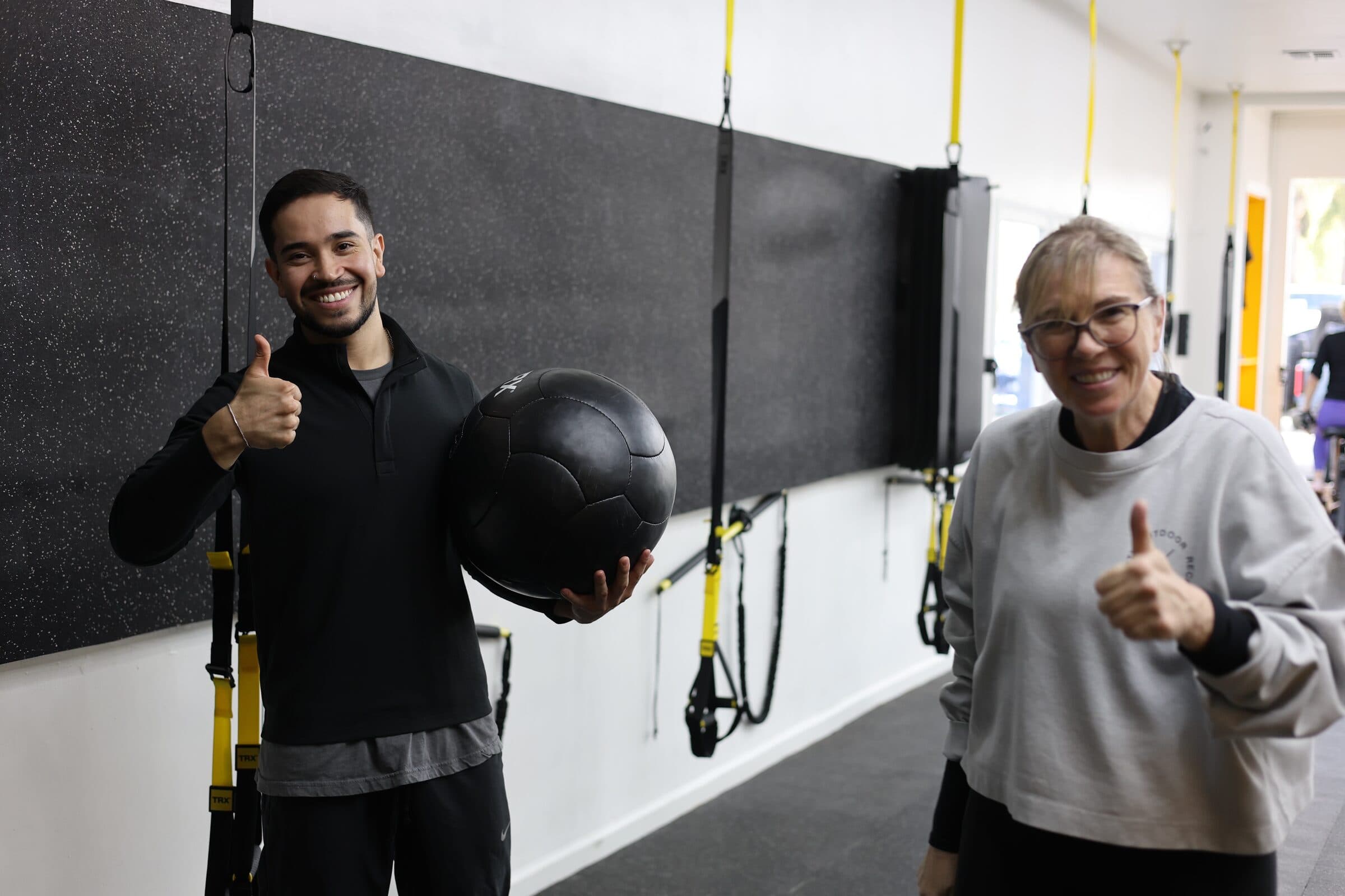 A Pure Function coach and client after a session on the training floor